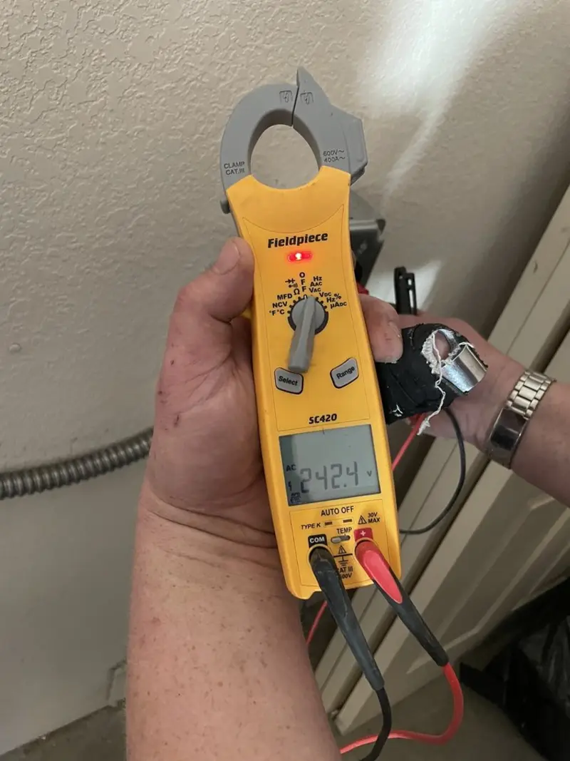 Voltage testing with clamp meter during Recessed Lighting Installation in Carnegie